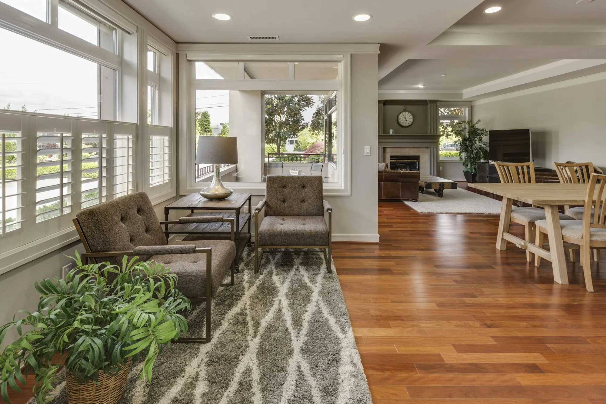Sunroom-style living area with plantation shutters and wood floors